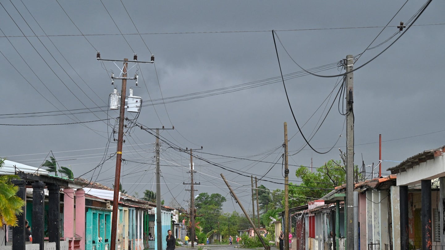 A man walks on a street during the pass of the Hurricane Rafael's eye in Pueblo Candelaria, Artemisa Province, on November 6.