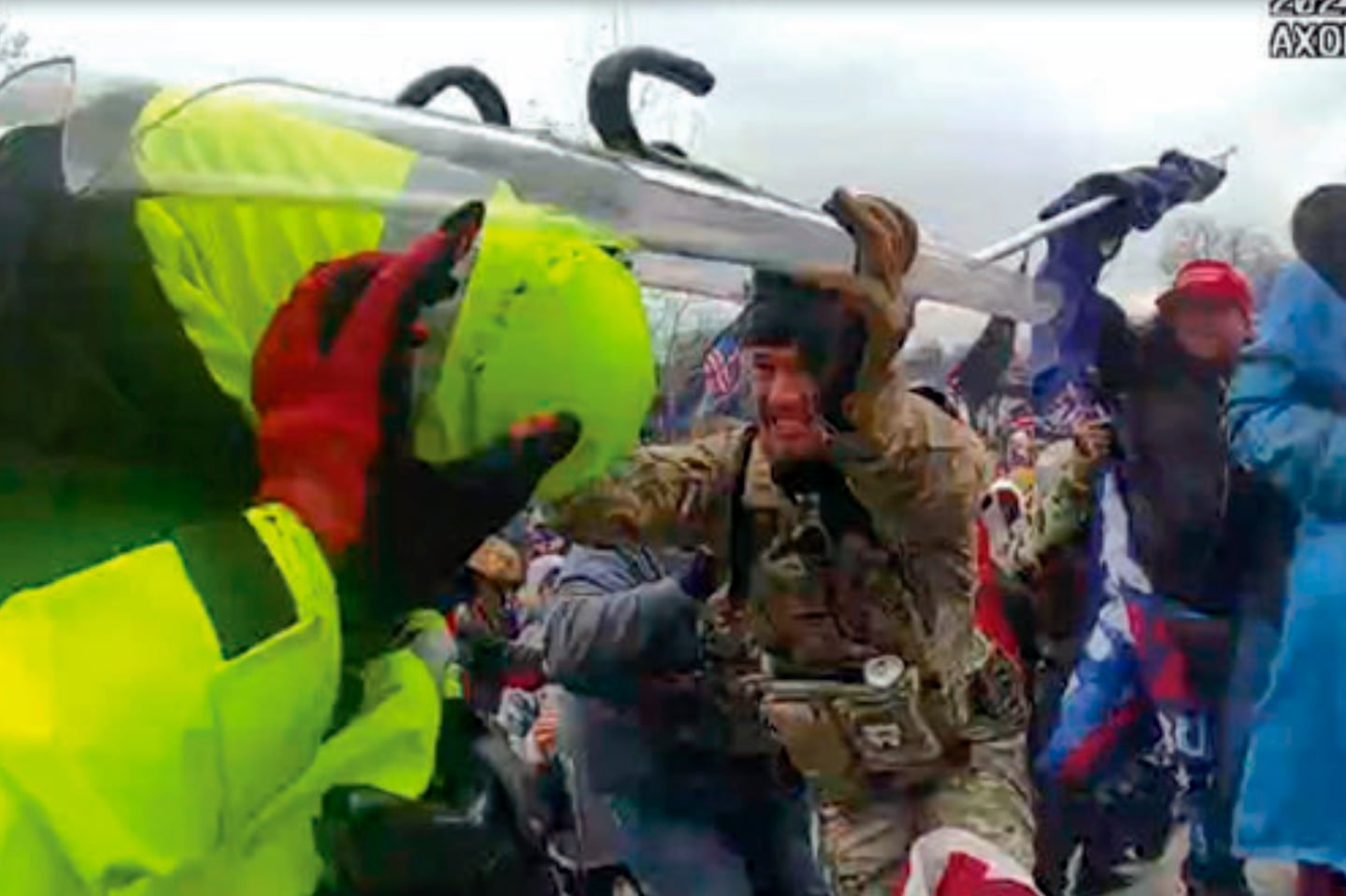 This image from police body-worn camera video shows Jonathan D. Pollock holding a police riot shield at the US Capitol on Jan. 6, 2021, in Washington.