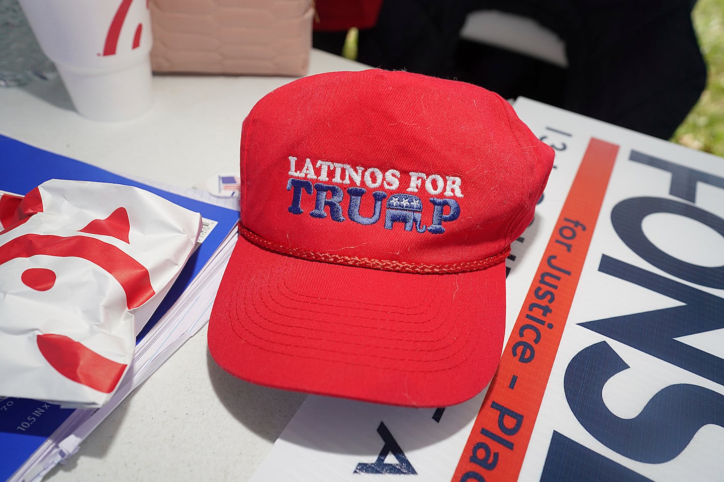 A Latinos for Trump hat rested on a table outside a polling place at Lark Community Center on March 5, 2024, in McAllen, Texas.