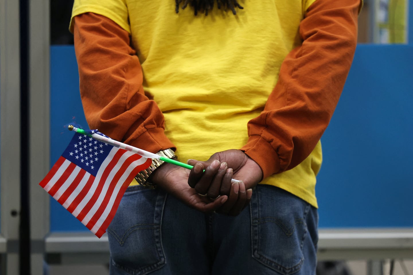 An election worker holds a flag while assisting voters at a polling station in Las Vegas, Nevada, on Election Day, Nov. 5, 2024.