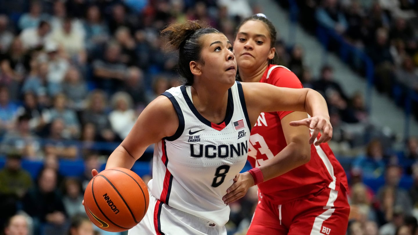 UConn freshman Jana El Alfy drives past Boston University's Channing Warren #23 on Thursday night.