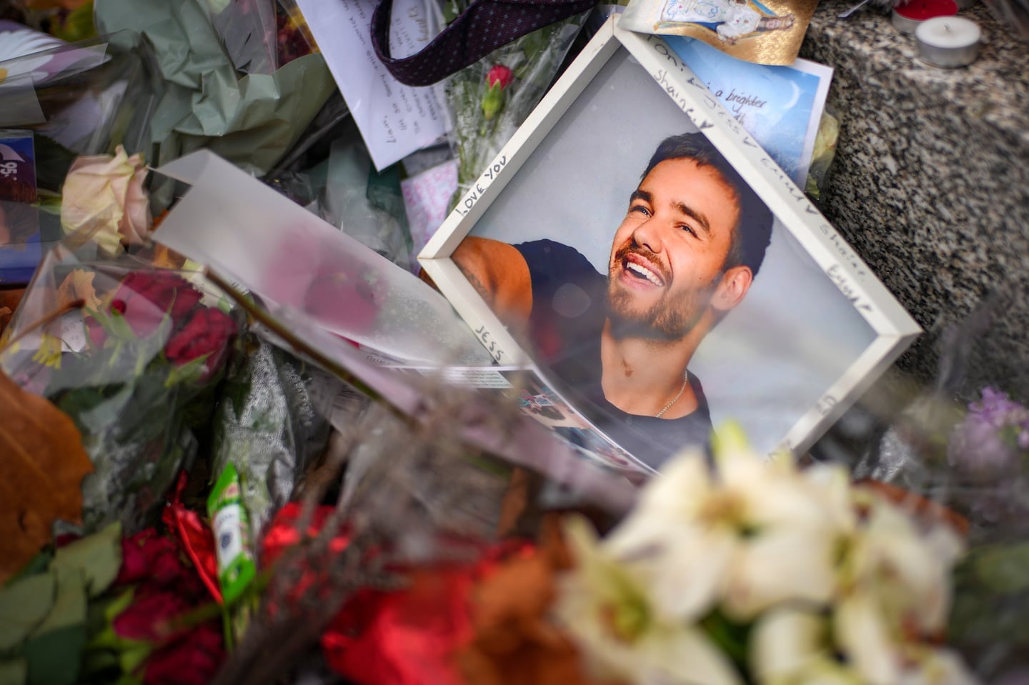 WOLVERHAMPTON, ENGLAND - NOVEMBER 05:  Flowers and tributes for One Driection's Liam Payne are left next to the Lady Wulfrun statue outside St. Peter's Collegiate Church on November 05, 2024 in Wolverhampton, England. Fans of Liam Payne are petitioning for a permanent memorial to be erected in Wolverhampton, the hometown of the former One Direction star. Payne tragically fell to his death from a hotel balcony in Buenos Aires on October 16. (Photo by Christopher Furlong/Getty Images)