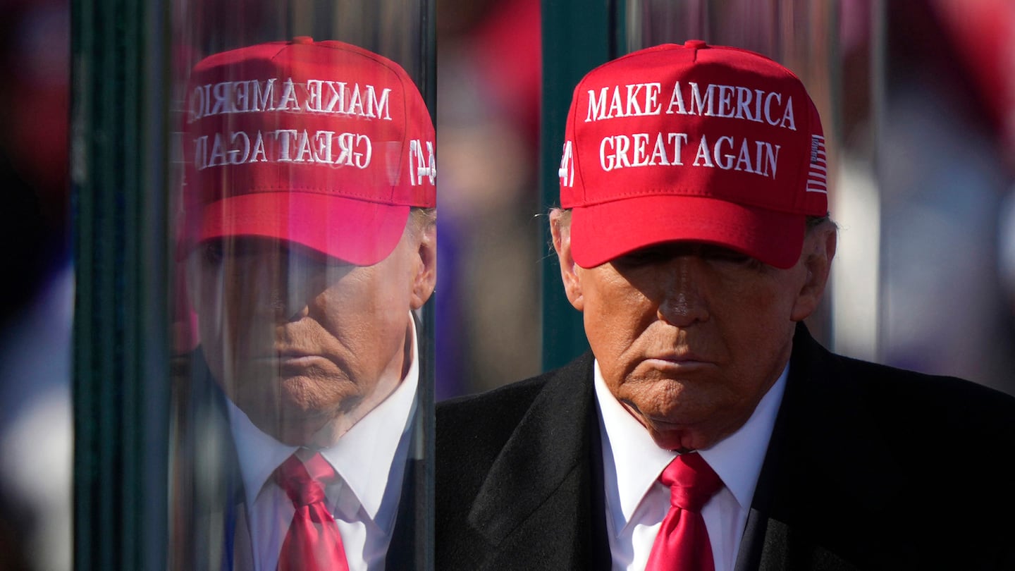 President-elect Donald Trump is reflected in the bullet proof glass as he finishes speaking at a campaign rally in Lititz, Pa., on Nov. 3.