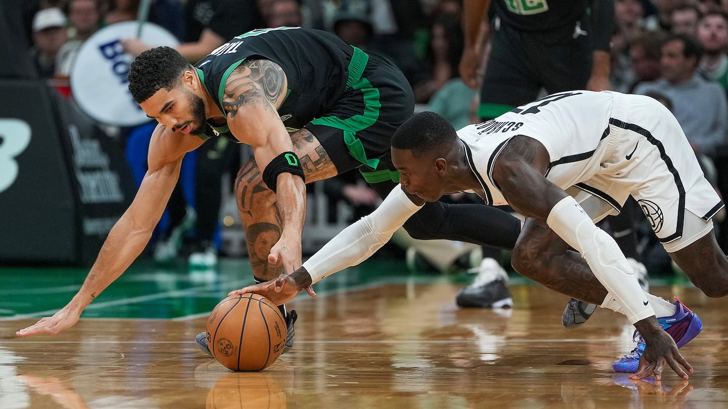 Celtics forward Jayson Tatum (left) and Nets guard Dennis Schröder vied for a loose ball during the first quarter at TD Garden.