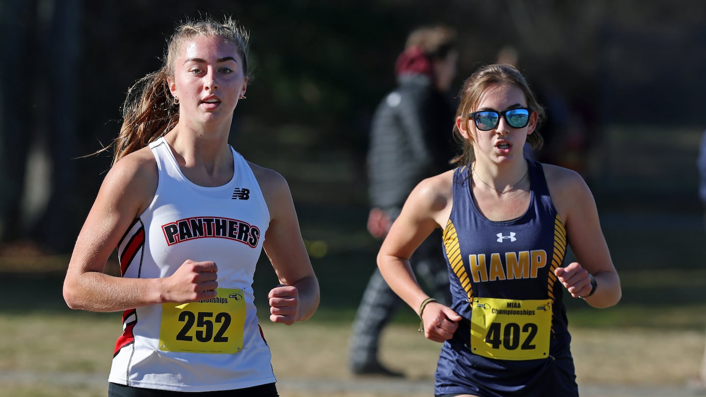 Holliston's Maggie Kuchman (left), the defending Division 2 champion, pulled away for a 24-second victory in the Division 2B race at Fort Devens.