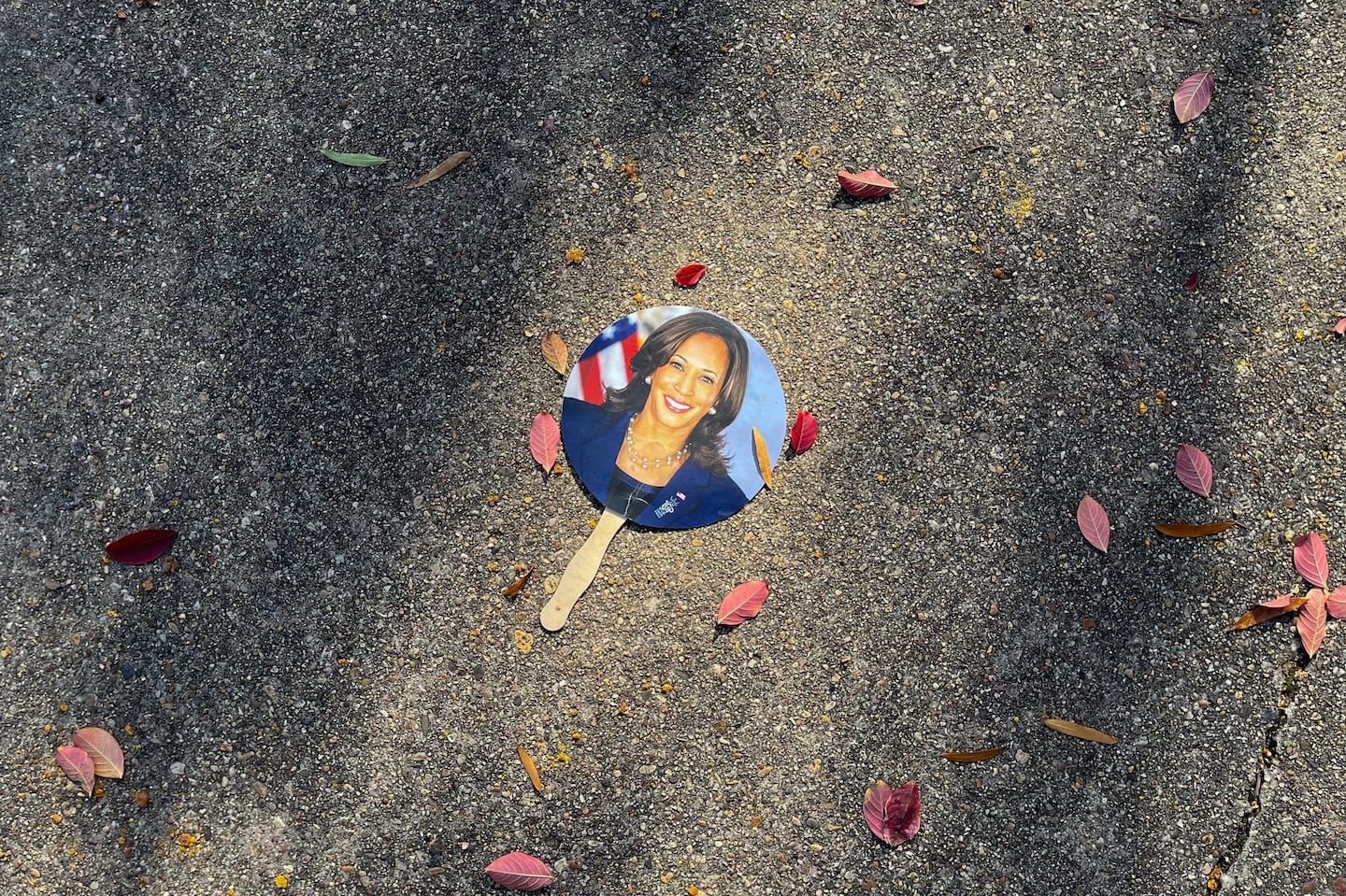 A hand fan depicting Vice President Kamala Harris lay on a sidewalk in Washington, D.C., on Wednesday.