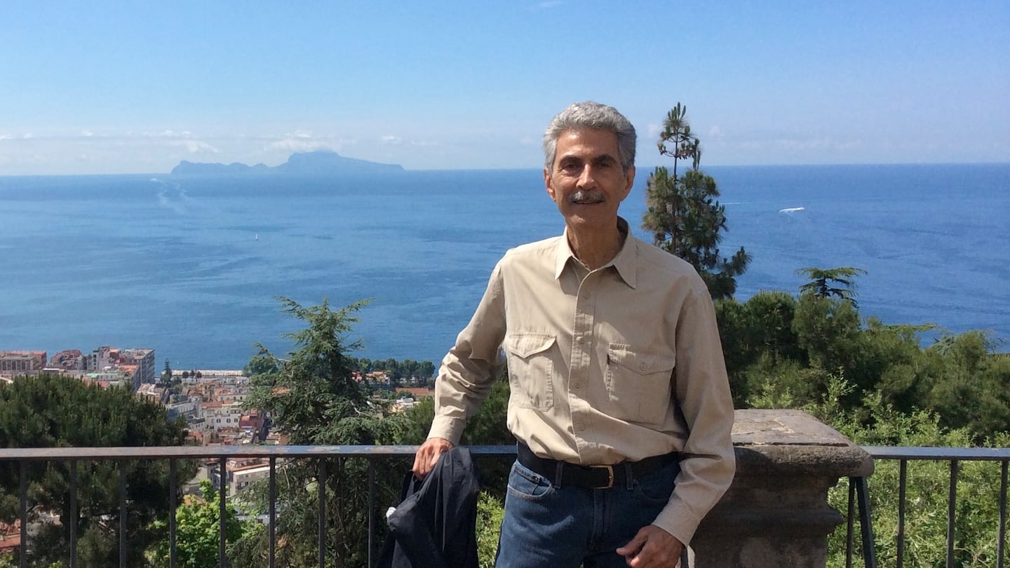 Mr. Sansolo in Naples in 2014, with Capri in the distance. Italy was a favorite destination for traveling with his husband, Dean Waller.