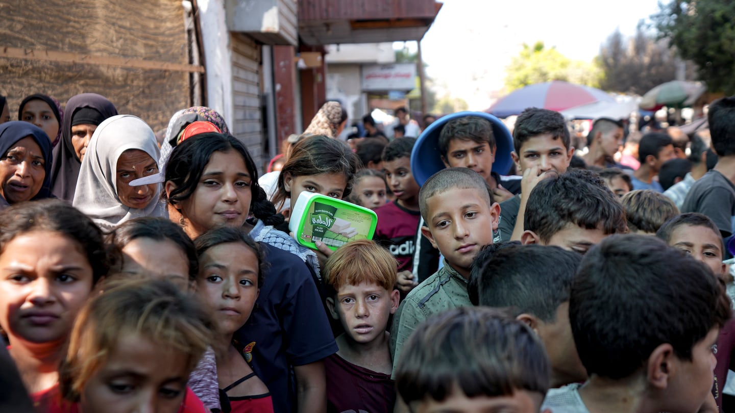 Palestinians line up for food distribution in Deir al-Balah, Gaza Strip, on Oct. 17.