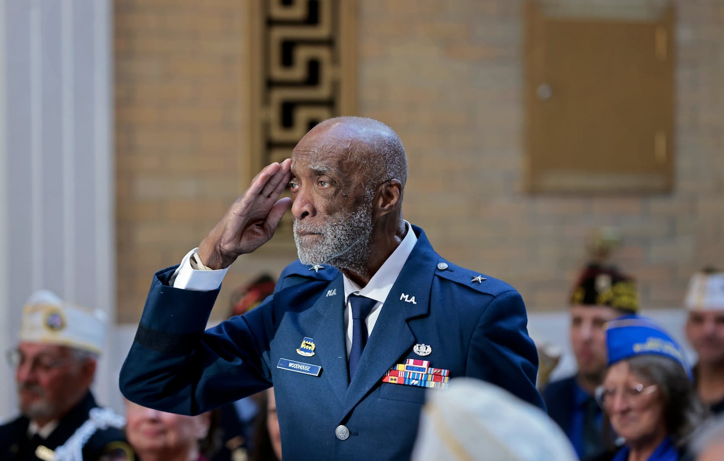 Brigadier General Enoch “Woody” Woodhouse II, 98, saluted as he entered the Hall of Flags during a Veterans Day ceremony at the State House on Monday.