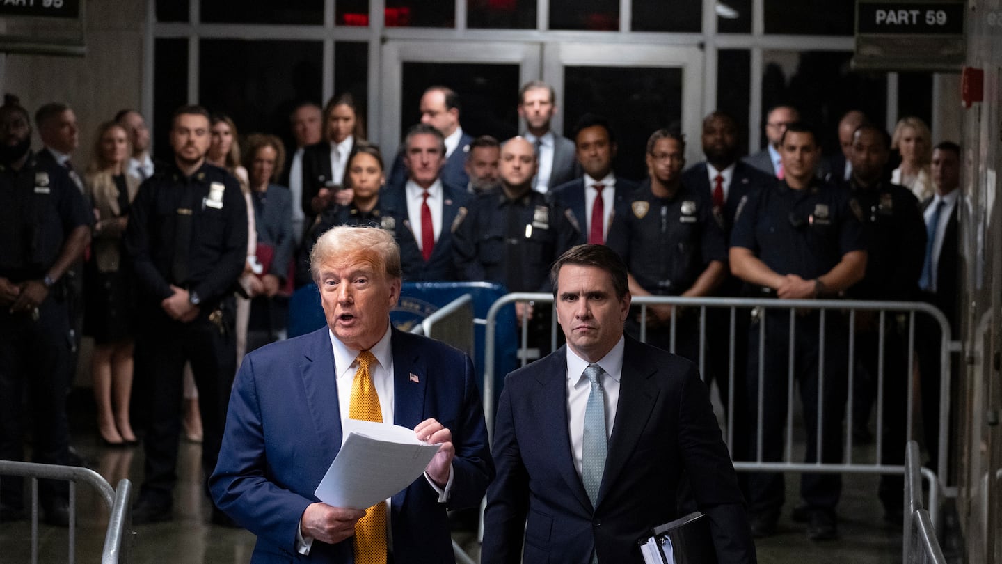 Former president Donald Trump, standing with defense attorney Todd Blanche, speaks at the conclusion of proceedings at his trial at Manhattan criminal court, on May 14, in New York.