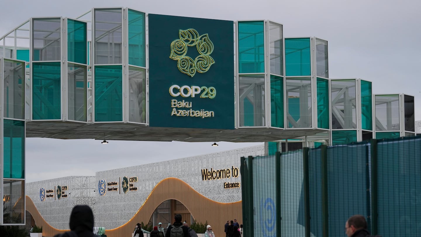 People arrive for the COP29 U.N. Climate Summit, Wednesday, Nov. 13, 2024, in Baku, Azerbaijan.