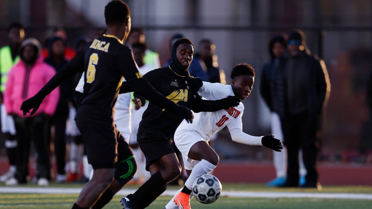 Boston International's William Bazelais of Boston International (center) and Wiskenly Fils-Aime of TechBoston fight for possession during the first half.