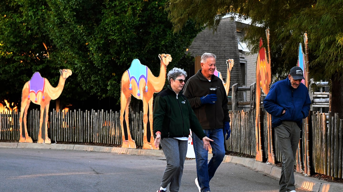 Members of the Get Healthy Walking Club walked the paths past the animal enclosures during the early morning at the Louisville Zoo in Louisville, Ky.