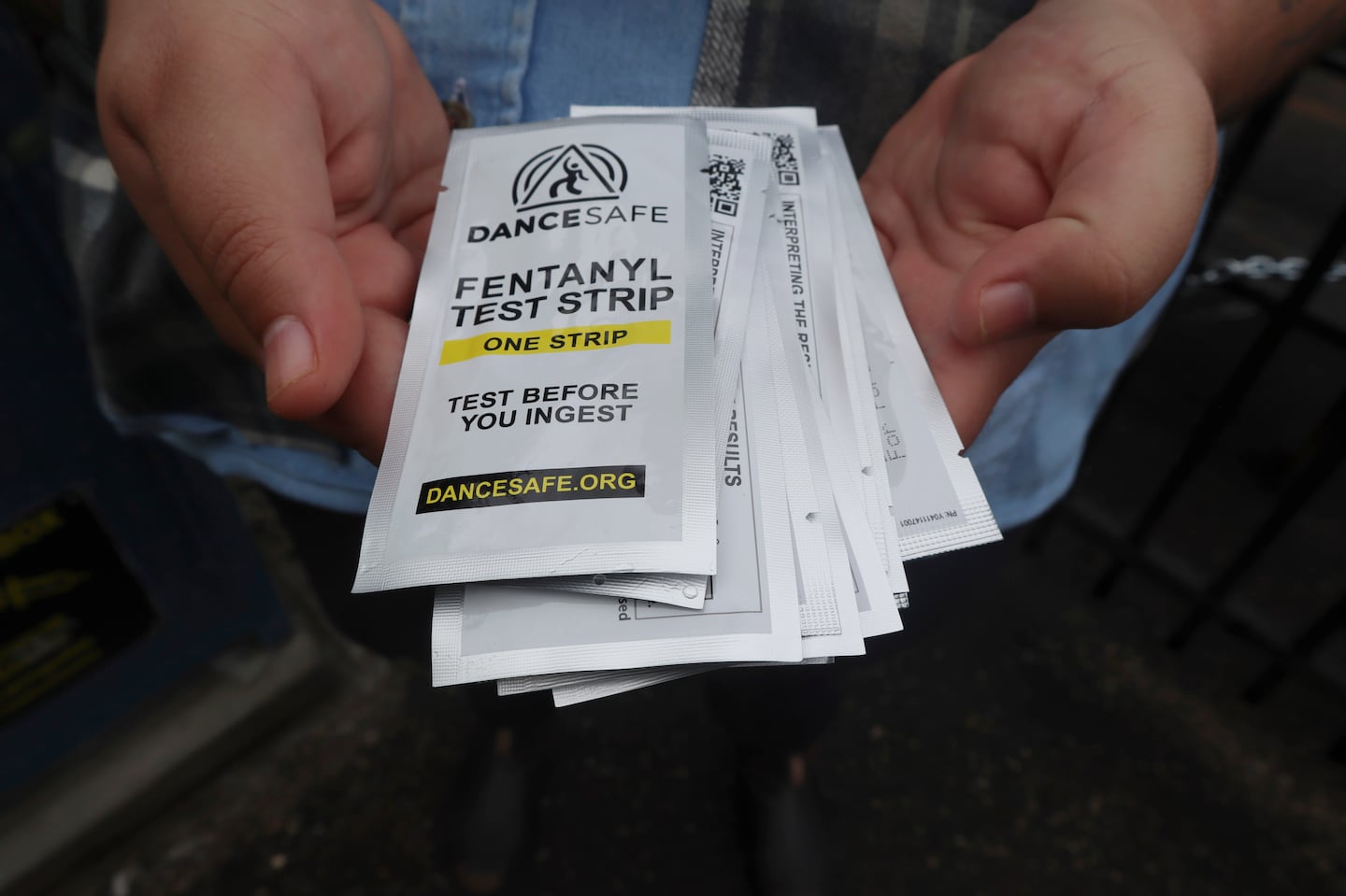 Iris Sidikman, harm reduction coordinator at the Women's Health Center of West Virginia, holds fentanyl testing strips the clinic has on hand to give people dealing with substance use disorder in the clinic parking lot on Aug. 4, 2023, in Charleston, W.Va.