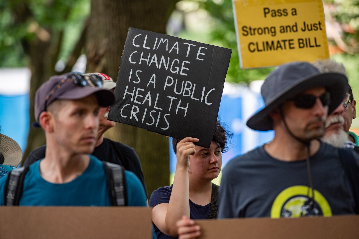 Climate activists rally in Boston Common before marching to the State House in Boston, Massachusetts, on July 14, 2024. Activists are calling on the state legislature to pass climate bills to help the environment and the people living in it.