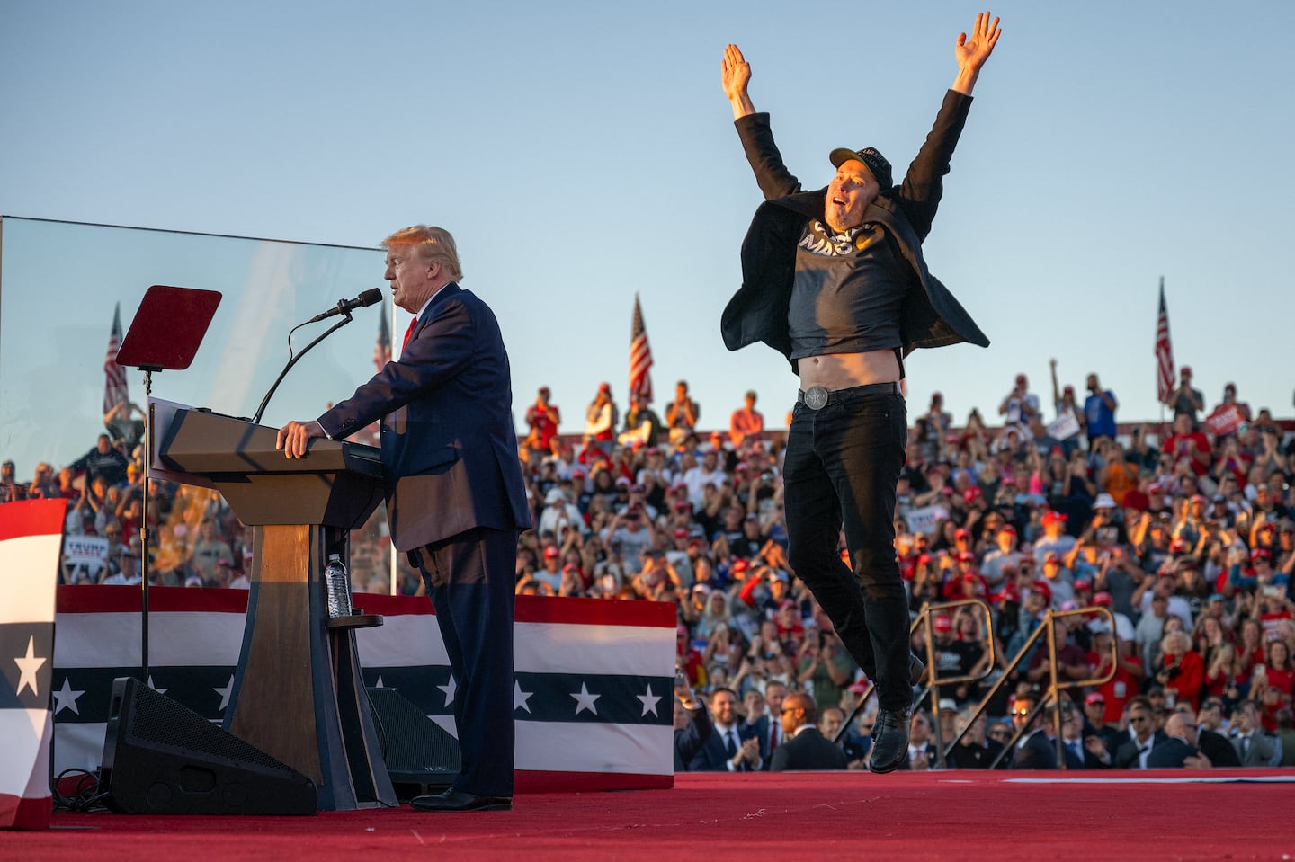 Elon Musk jumping for some reason while Donald Trump speaks at a campaign rally in Butler, Pa., on Oct. 5.