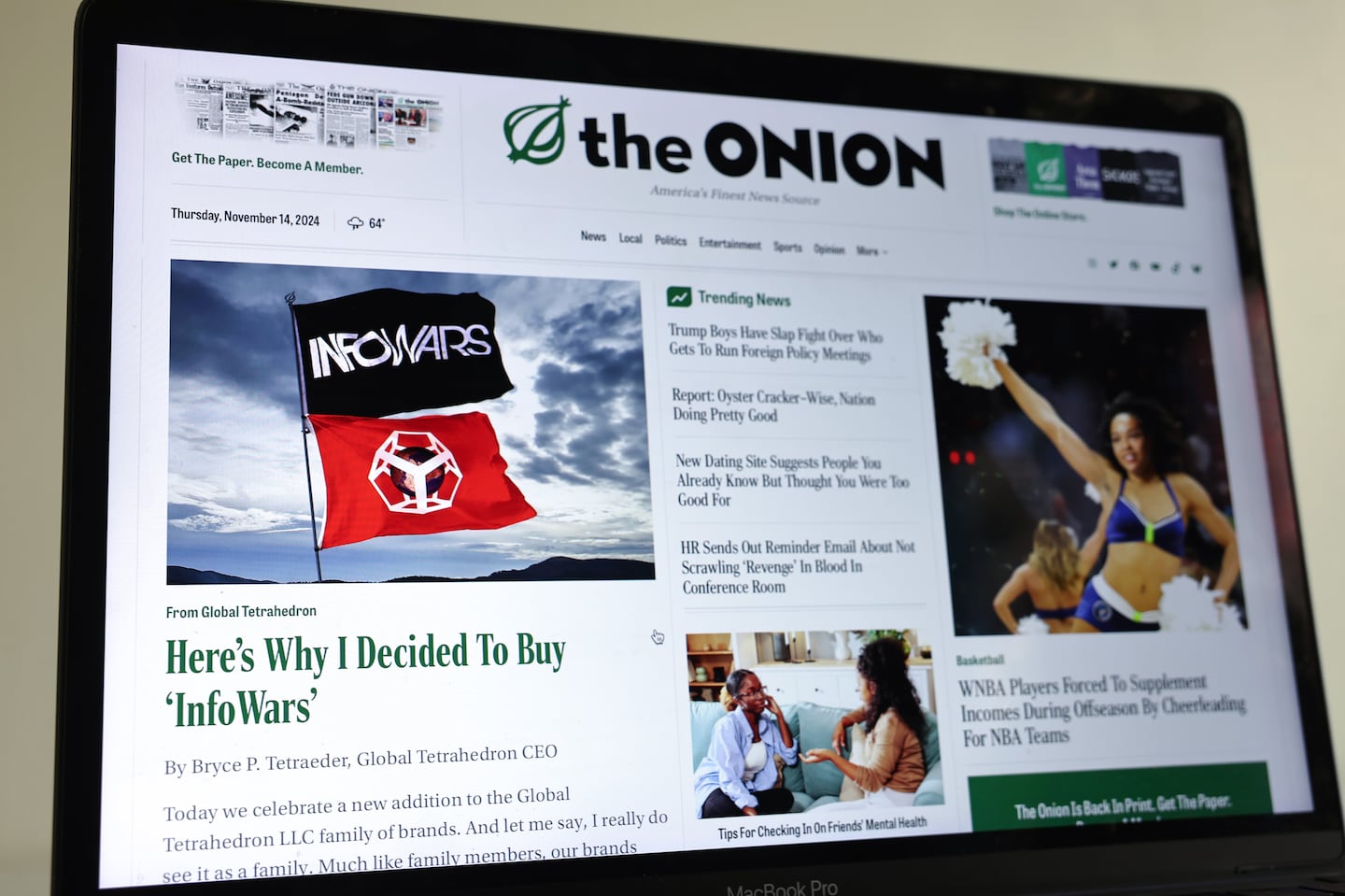 In this photo illustration, The Onion home page is displayed on a computer screen, showing a satirical story.