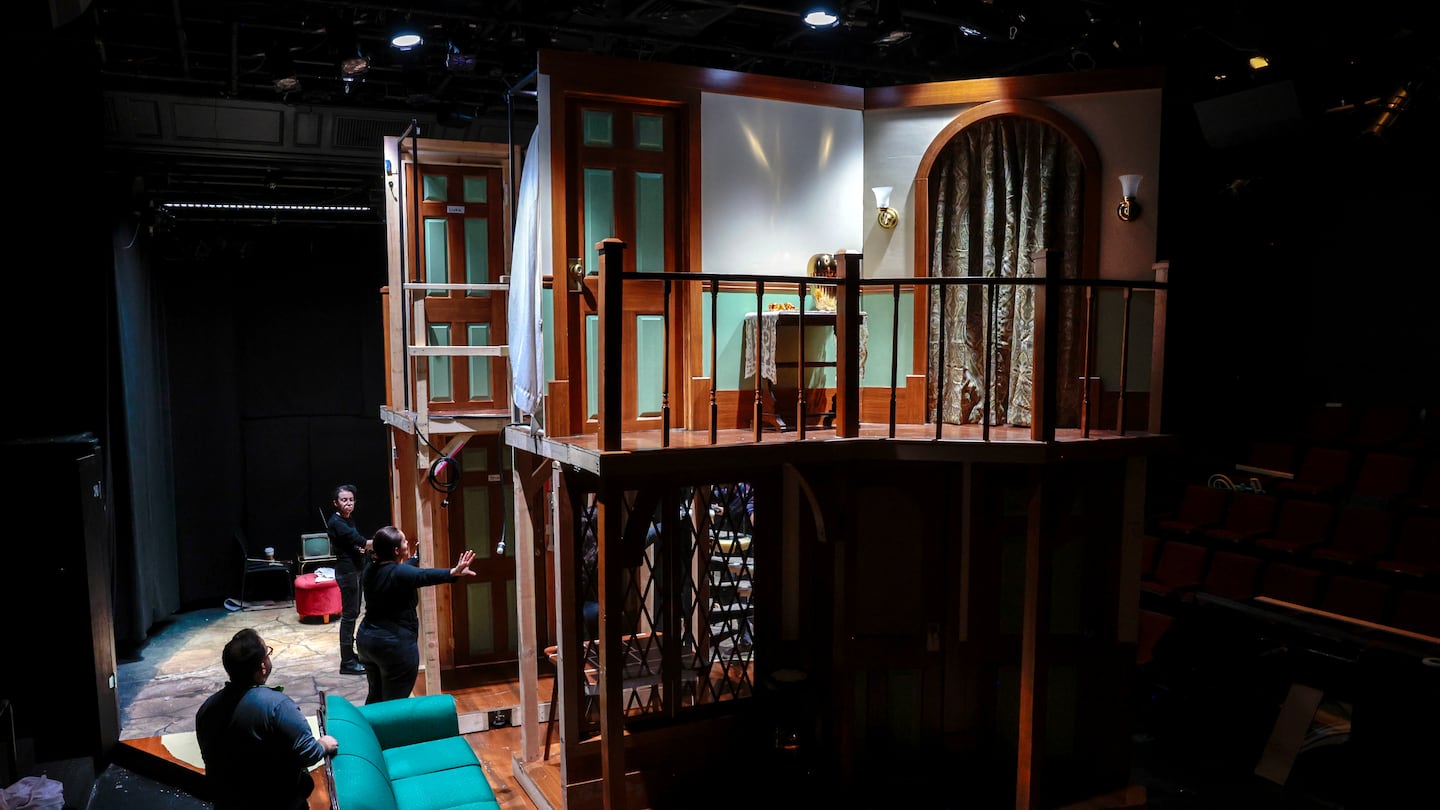  Set designer Erik Diaz, left, watches crew members flip the set during a dress rehearsal for the Lyric Stage Company production of "Noises Off" in Boston on Nov. 12, 2024. 