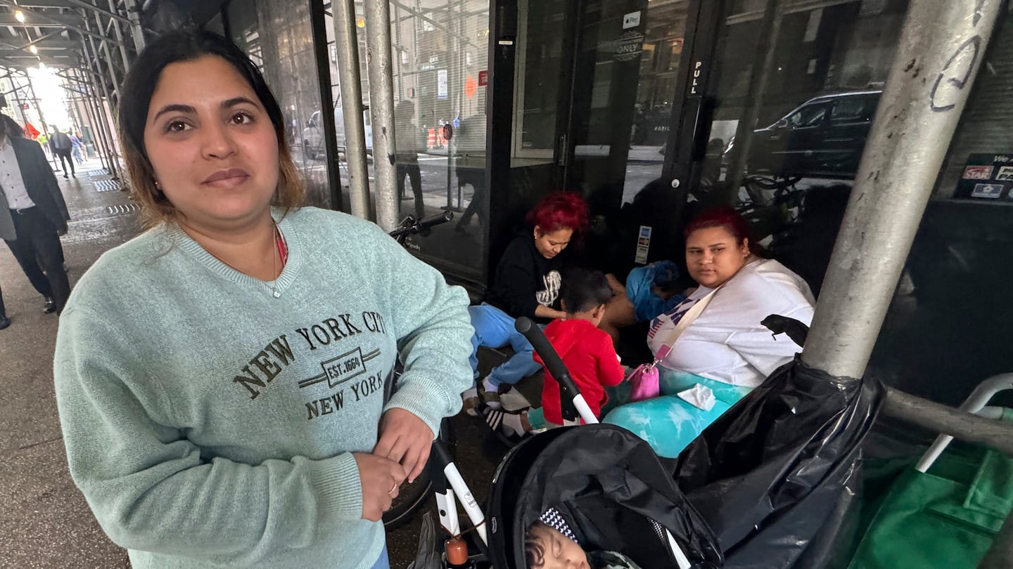 Maribel Hidalgo of Caracas, Venezuela, stands for a portrait with her son, Daniel outside a shelter for immigrants in New York, on Wednesday, Nov. 6, 2024.