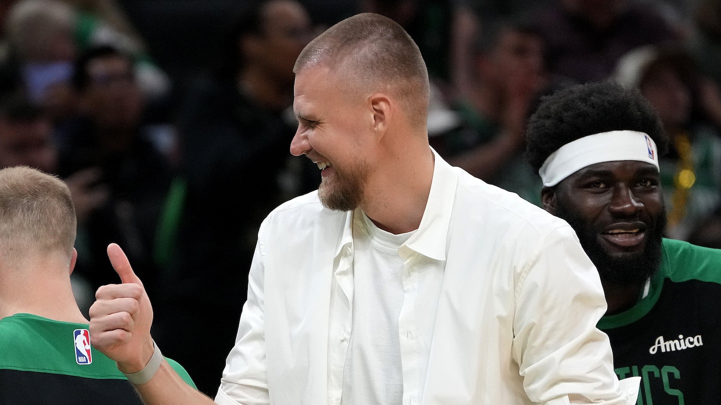 Sidelined center Kristaps Porzingis has been staying engaged with the Celtics, going on road trips and offering input during games.