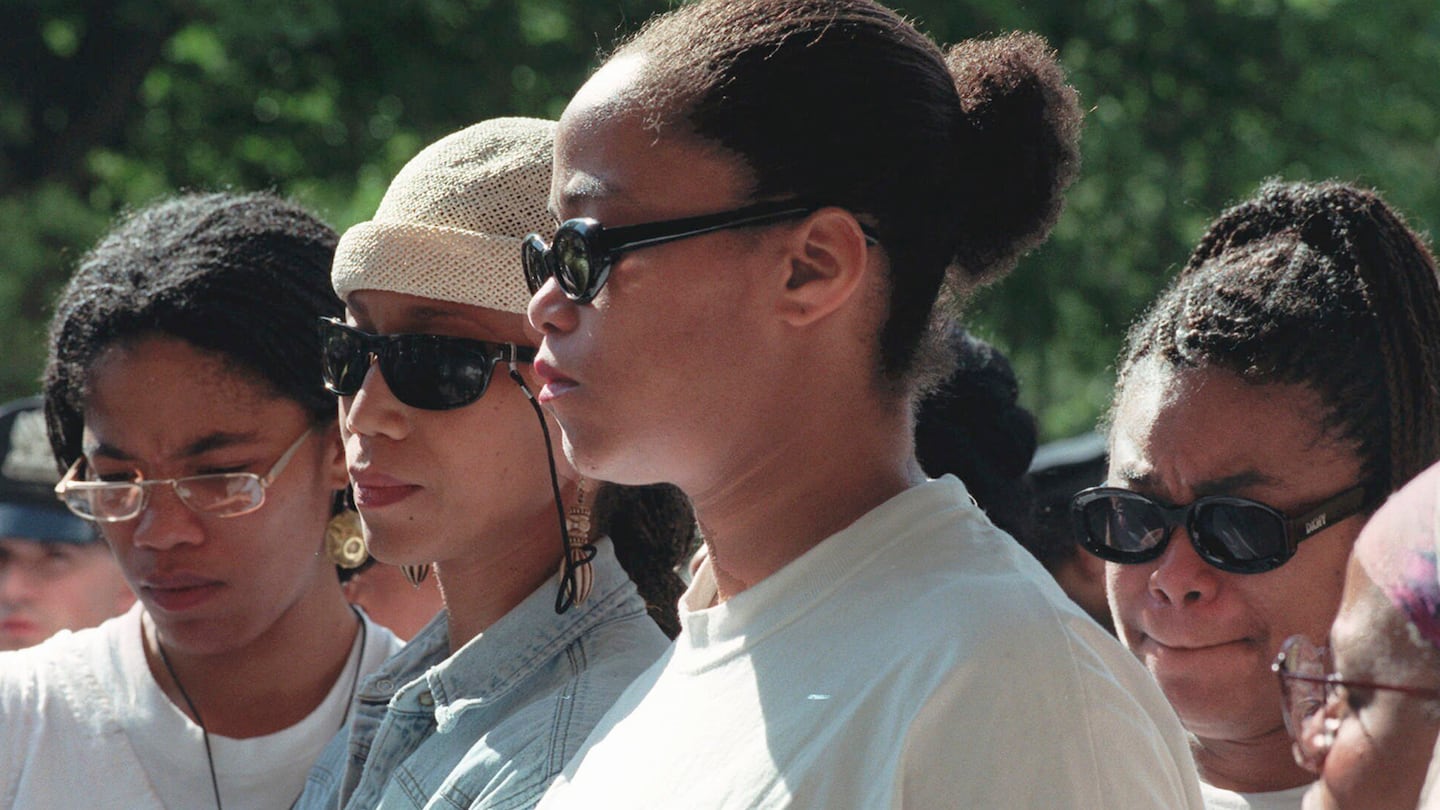 FILE - Malcolm X's daughters Malikah Shabazz, left, Attallah Shabazz, second from left, Malaak Shabazz, third from left, and Gamilah Shabazz, talk to the media outside the Jacobi Medical Center in the Bronx borough of New York, following the death of their mother, Betty Shabazz, June 23, 1997.