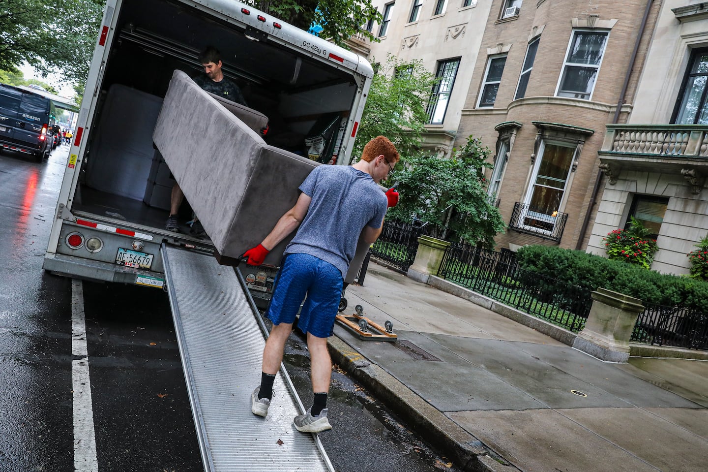 Kyle Needs (left) and Trevor Callahan carried a couch out of a van while helping a friend move in Boston in 2021.