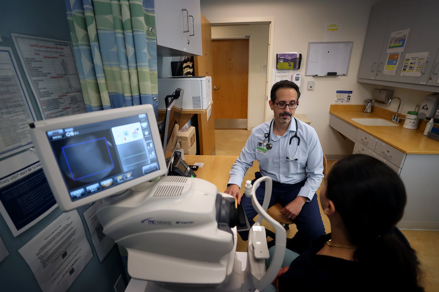 Dr. Asaf Bitton working at BWH South Huntington Primary Care. Bitton is a primary care doctor and associate professor of medicine and health care policy at Harvard Medical School and the T.H. Chan School of Public Health. He has seen an uptick in interest among his peers to join concierge programs, in part because concierge doctors can spend more time with fewer patients.