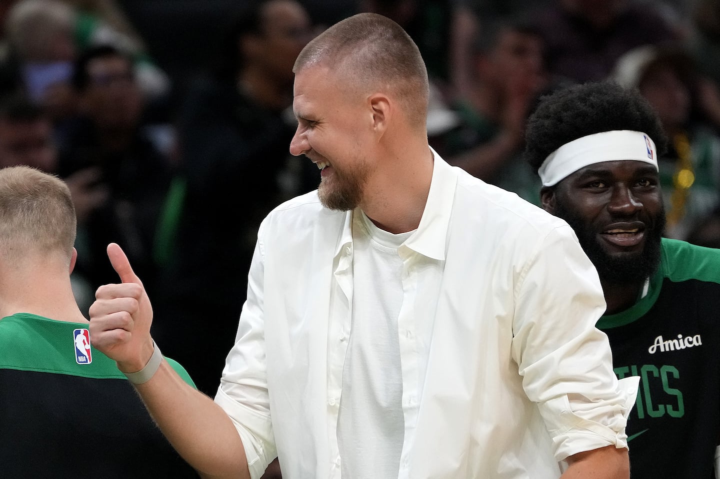 Sidelined center Kristaps Porzingis has been staying engaged with the Celtics, going on road trips and offering input during games.