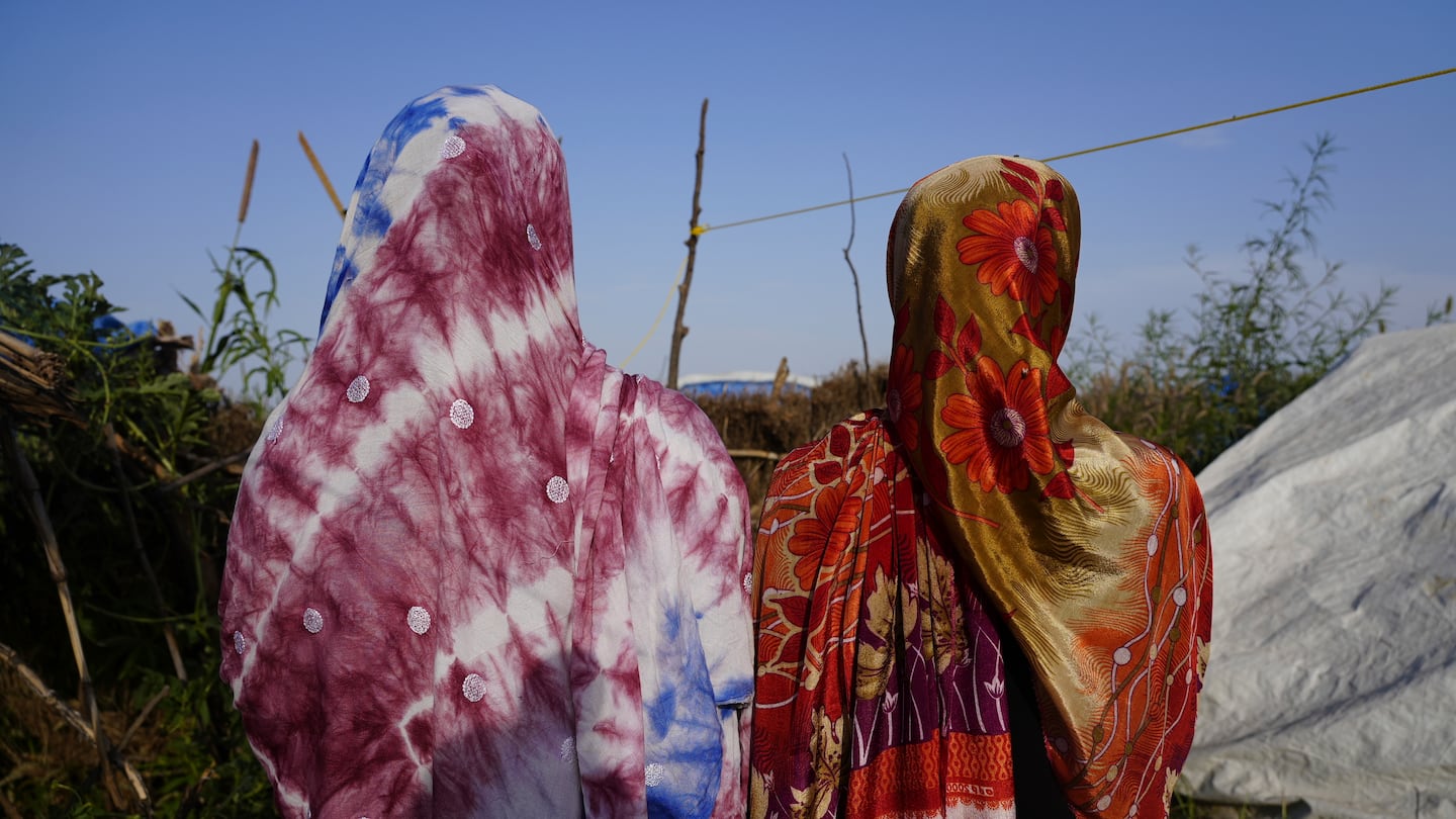 Women who fled war in Sudan and requested anonymity because they feared retribution after reporting sexual exploitation, walk in a refugee camp in Adre, Chad, on Oct. 5.