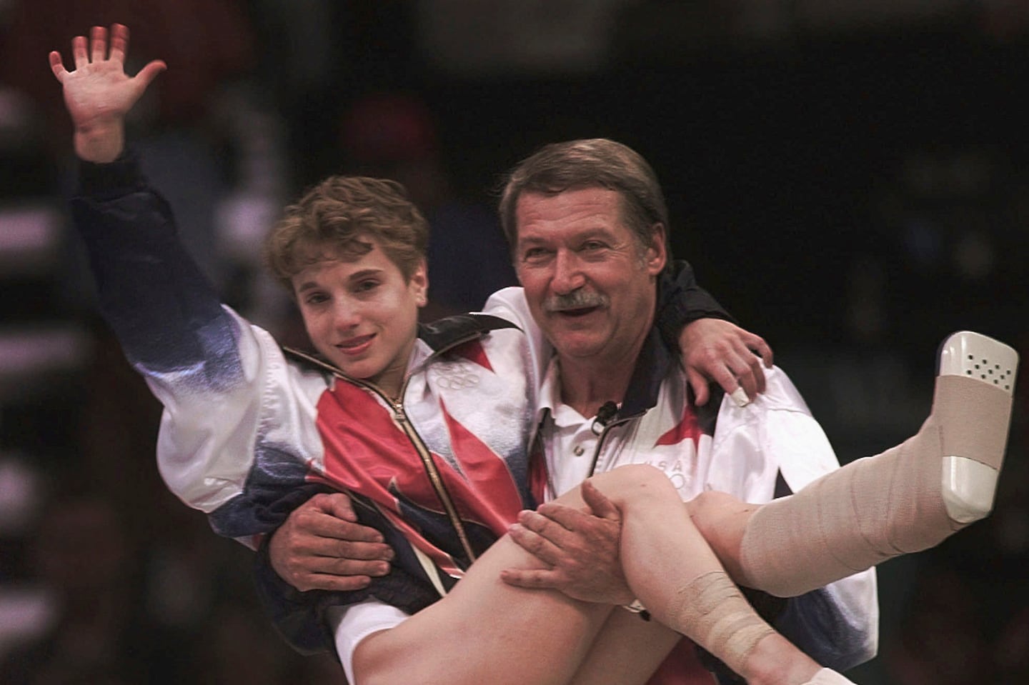 Former US women's gymnastics coach Bela Karolyi carried Kerri Strug to receive her gold medal for women's team gymnastics competition at the Centennial Summer Olympic Games in Atlanta on July 23, 1996. Karolyi died Friday at the age of 82.