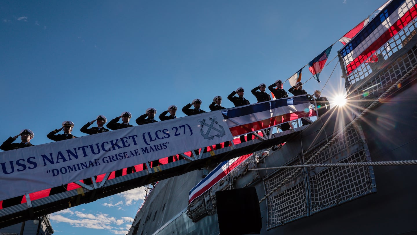 Crew members saluted after the commissioning of the USS Nantucket during a ceremony at the Charlestown Navy Yard.