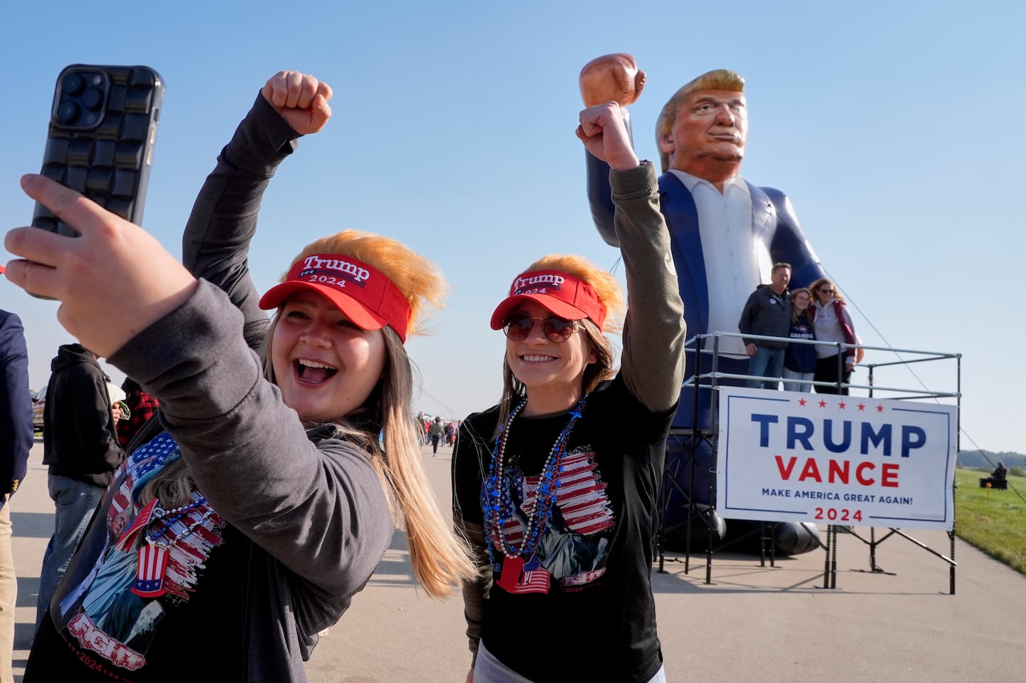 Kellie Kamphuis and Faith Rail took a selfie in front of an inflatable Donald Trump on Oct. 6 in Juneau, Wis.