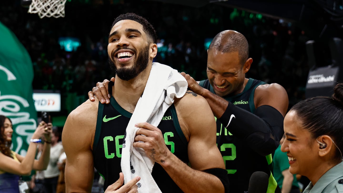 Al Horford (right) celebrates with Jayson Tatum after Tatum's 3-pointer at the overtime buzzer delivered the Celtics a Saturday night victory over the Raptors.