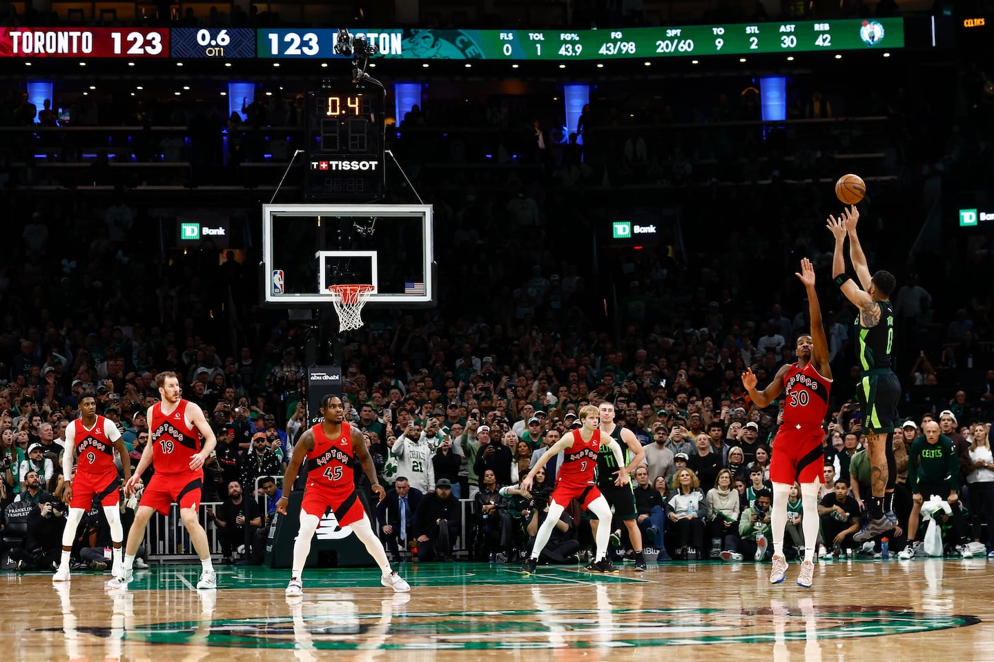 Jayson Tatum (far right) hit a 3-pointer as the clock expired in overtime on Saturday at TD Garden.