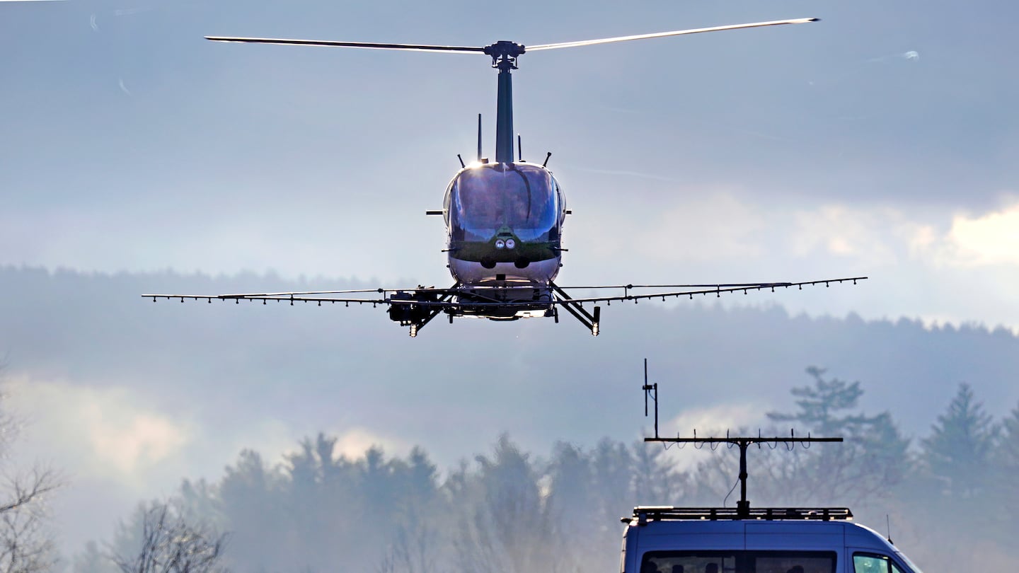 A Rotor Technologies unmanned semi-autonomous helicopter flies away from a van containing a ground control pilot/operator during a test flight over Intervale Airport, Nov. 11, in Henniker, N.H.