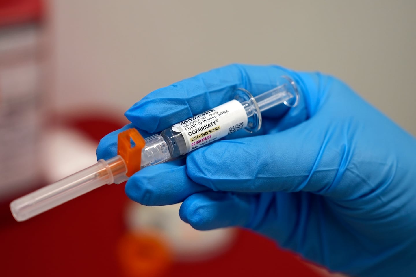 A pharmacist holds a COVID-19 vaccine at a pharmacy in New York in September.