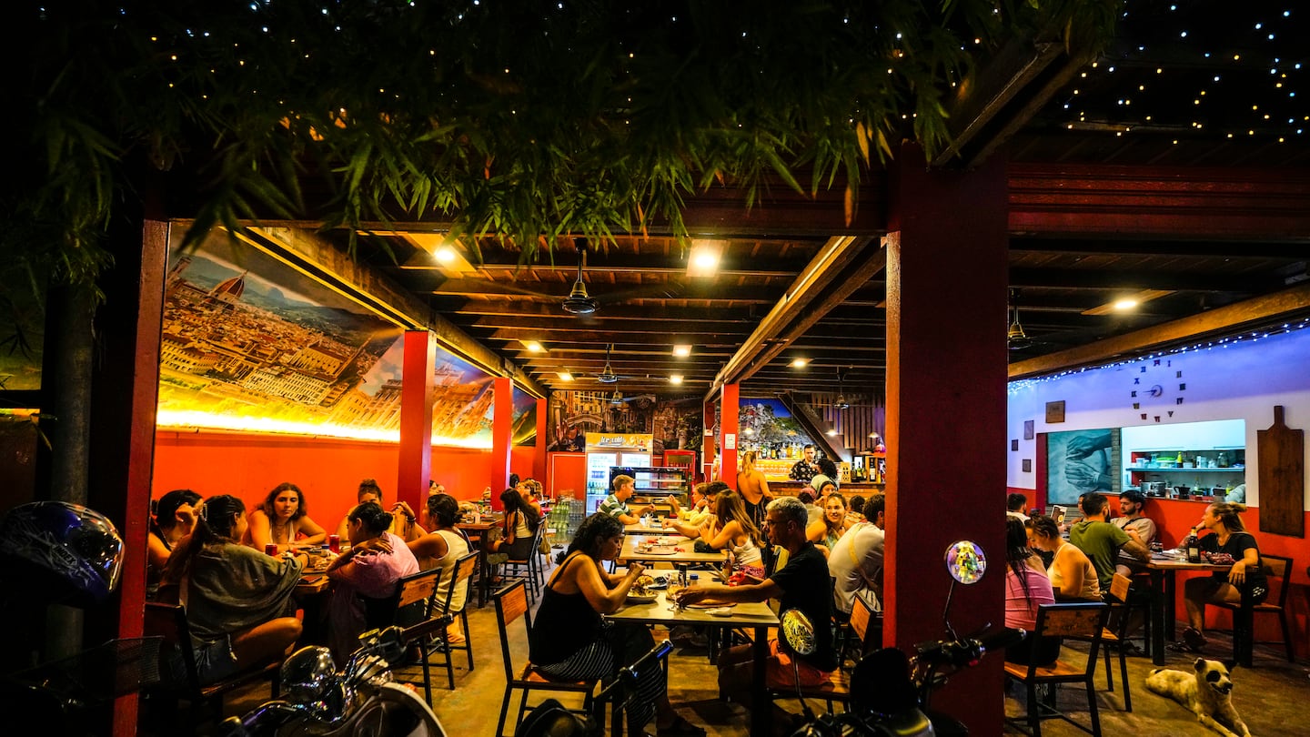 Foreign tourists have a drink at a night club at Nana Backpack hostel in Vang Vieng, Laos, on Nov. 19.