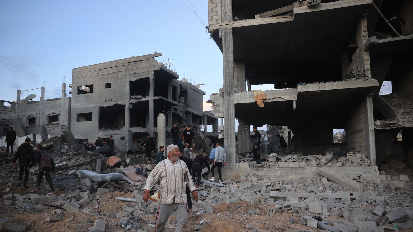 Palestinians inspected the damage at the site of an Israeli airstrike on the Bureij refugee camp in the central Gaza Strip on Nov. 19 amid the ongoing war between Israel and the Hamas militant group.