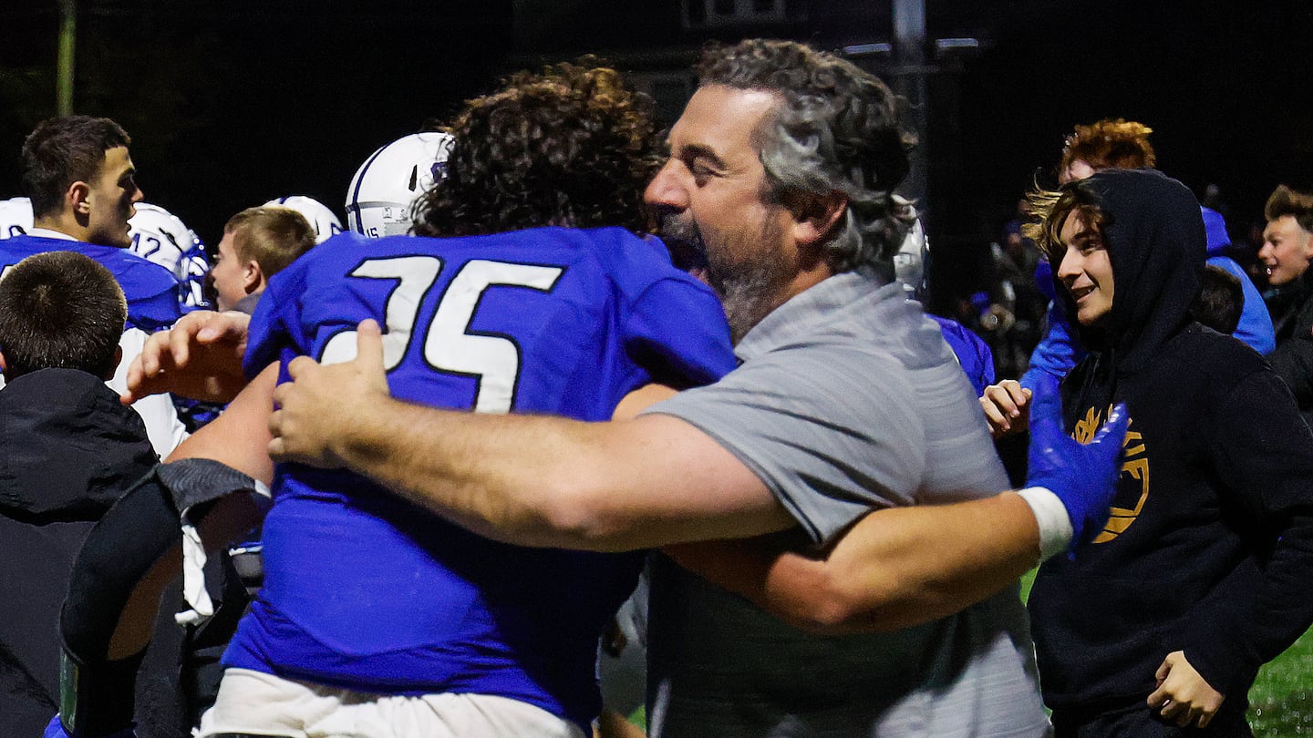 Justin Marques shared an emotional embrace with coach Derek Almeida after their 36-34 overtime win over Lynnfield in the Division 6 quarterfinals Friday night.