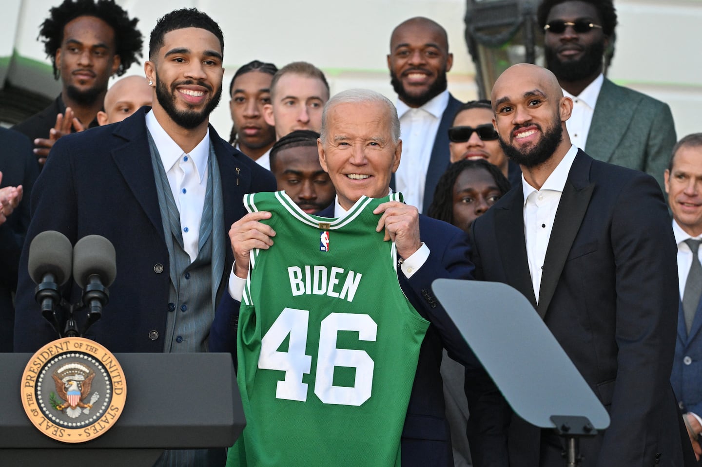 Jayson Tatum (left) and Derrick White (right) pose with President Joe Biden at the White House.