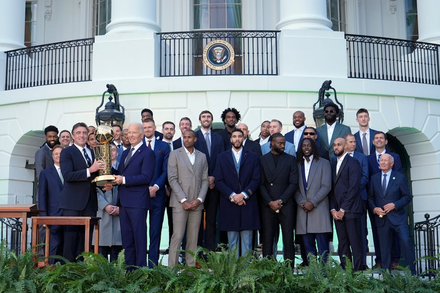 Boston Celtics owner Wyc Grousbeck (left) shared in the honor of hoisting the Celtics' NBA Championship trophy with President Joe Biden during a ceremony honoring the Celtics on the South Lawn of the  White House on Thursday.