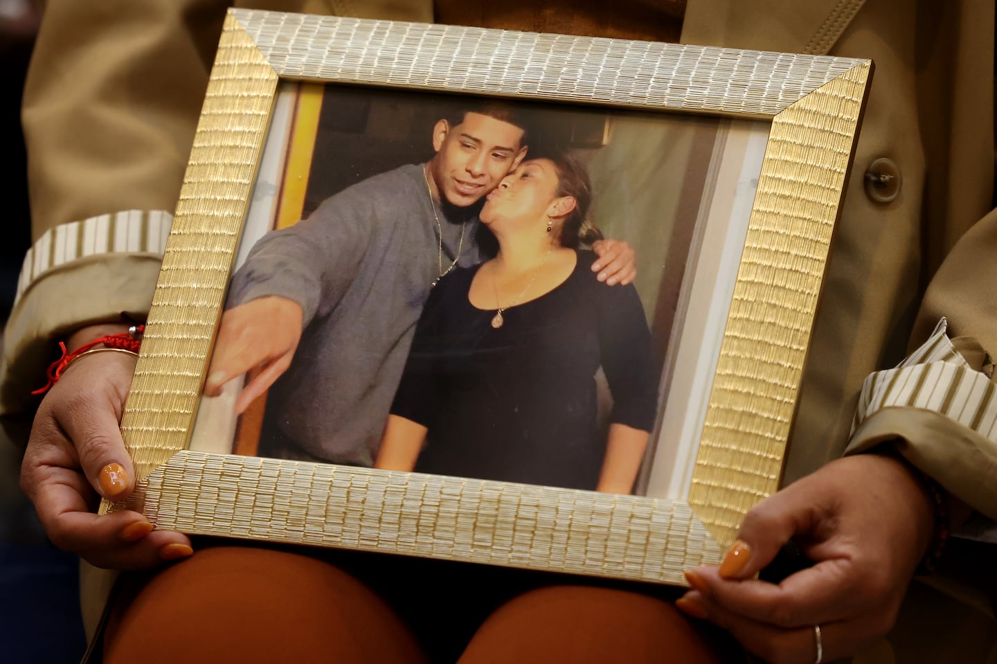 Beatriz Couho a Survivor Ambassador held a photo of her and her son, Joel Leon, who she lost to gun violence as she attended the 24th Annual Opening Ceremony held for Survivors of Homicide Victims Awareness Month.