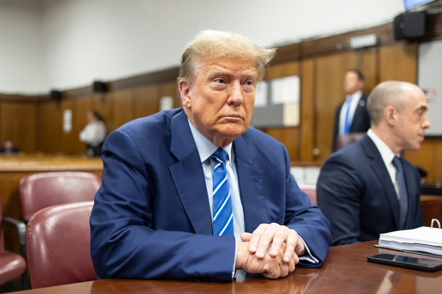 Former president Donald Trump awaits the start of proceedings on the second day of jury selection at Manhattan criminal court, April 16, 2024, in New York.