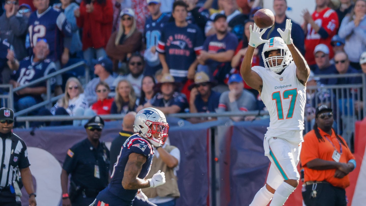 Jaylen Waddle makes a catch in front of Christian Gonzalez during the Patriots' first bout with the Dolphins this season in Week 6.