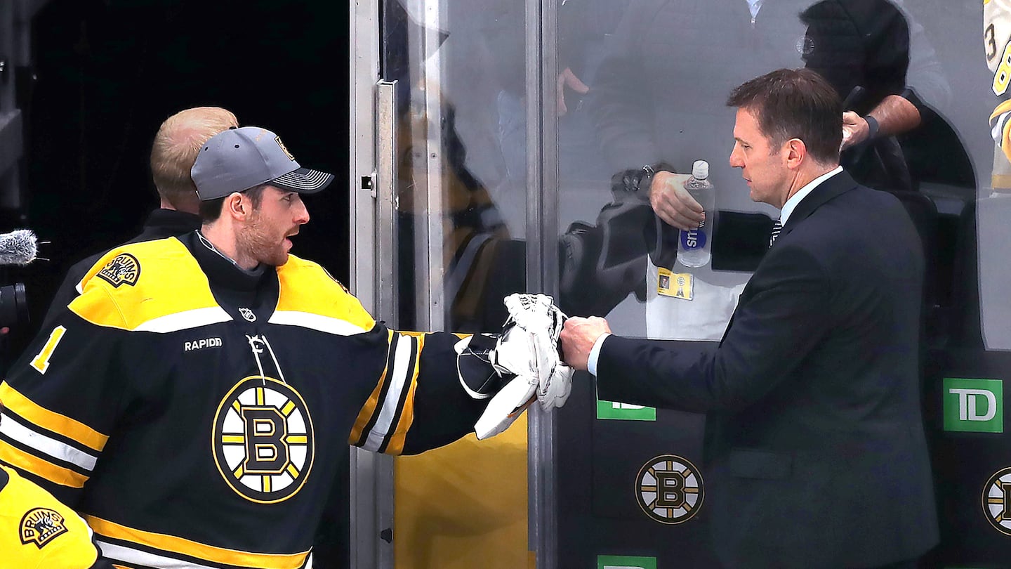 Joe Sacco (right) got a fist-bump from Jeremy Swayman after the Bruins notched a win in his first game as interim head coach.