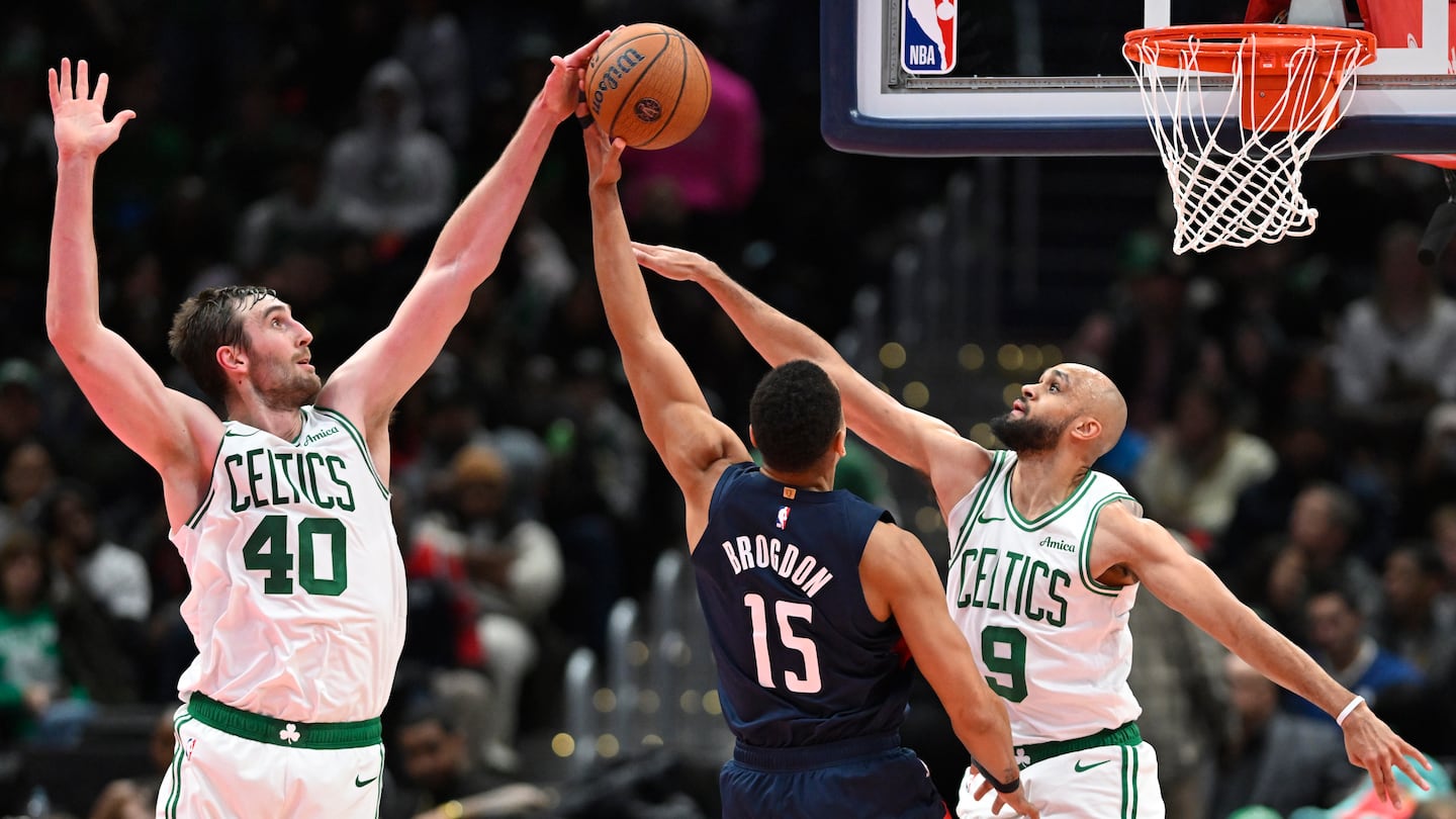 The Wizards' Malcolm Brogdon went for 18 points and 10 rebounds against his former team, but was denied on this shot attempt by Luke Kornet (left) and Derrick White.