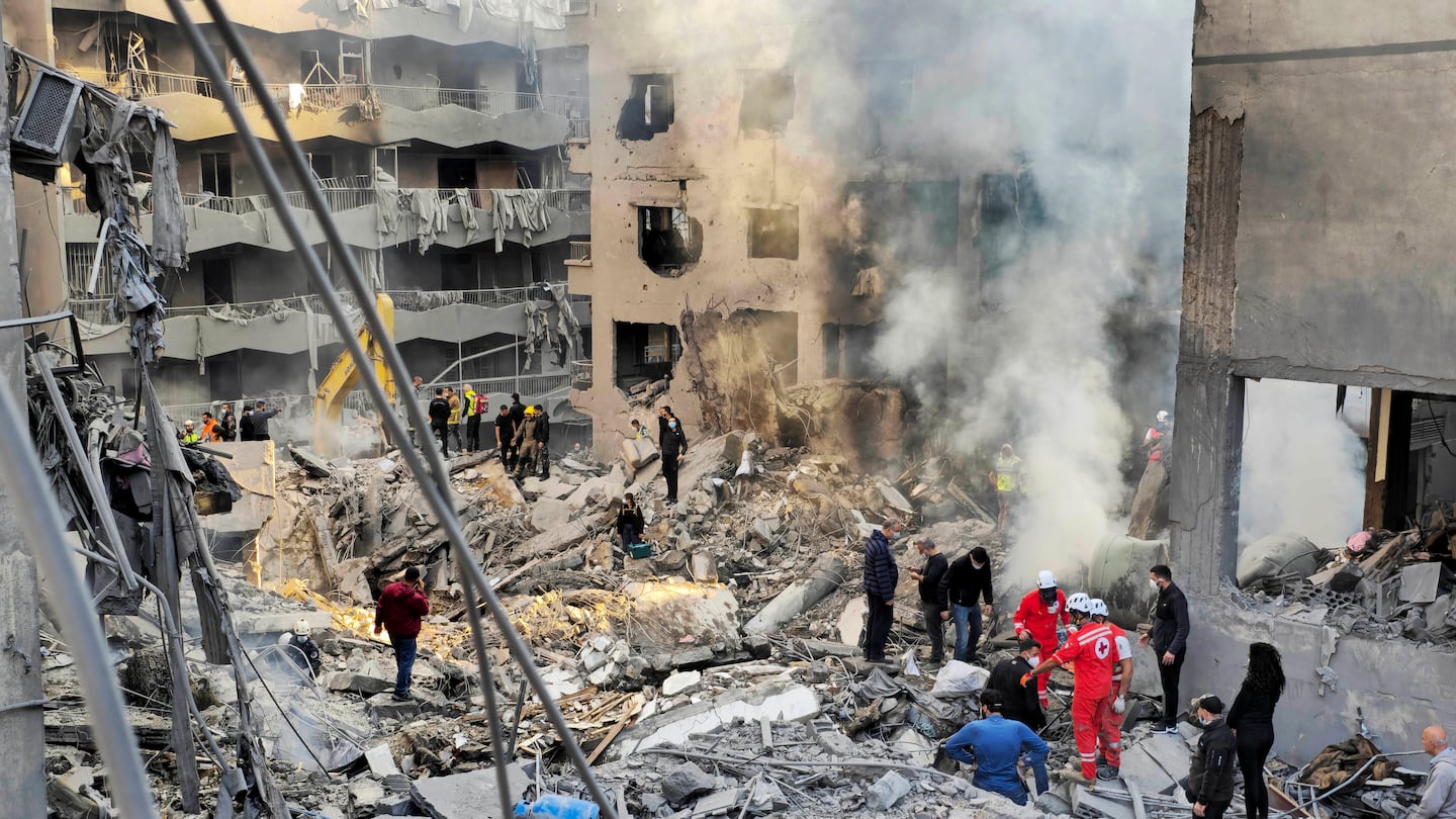 Rescue workers and people search for victims at the site of an Israeli airstrike in Beirut, Lebanon, on Nov. 23.