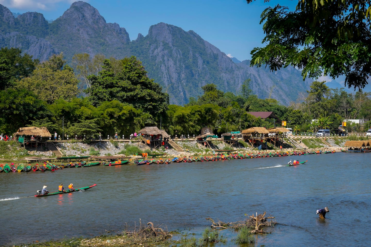 Foreign tourists rode on boat in a river in Vang Vieng, Laos, on Friday.