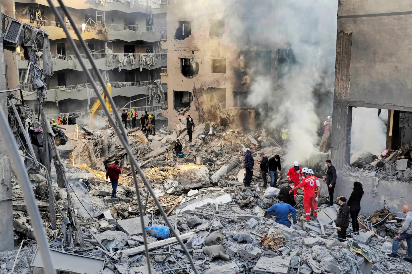 Rescue workers and people search for victims at the site of an Israeli airstrike in Beirut, Lebanon, on Nov. 23.