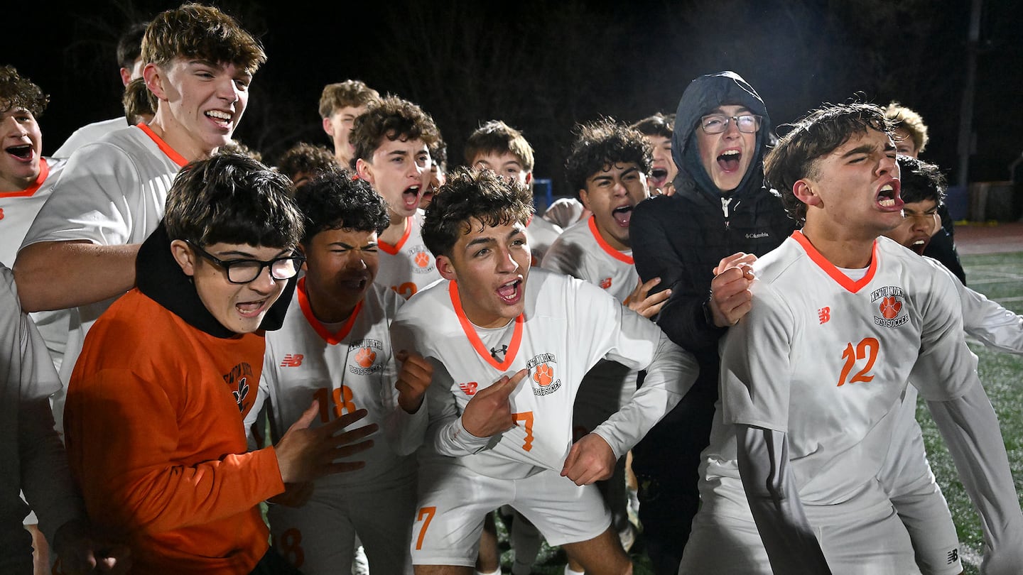 Euphoric Newton North players celebrate their unprecedented title.